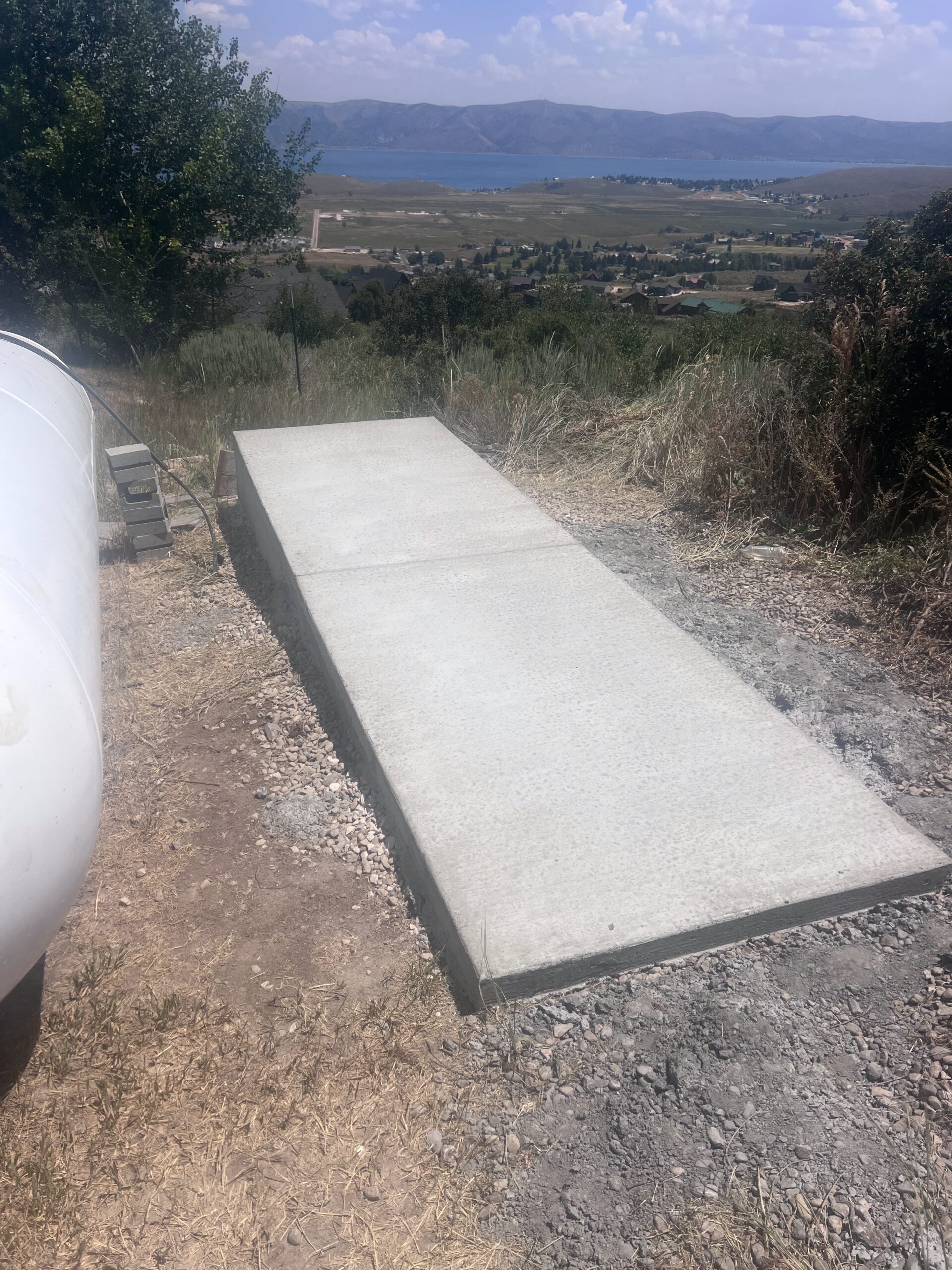 Concrete slab installation with scenic view of Bear Lake and surrounding landscape, showcasing quality craftsmanship in concrete work by Bear Essentials Handyman Services.