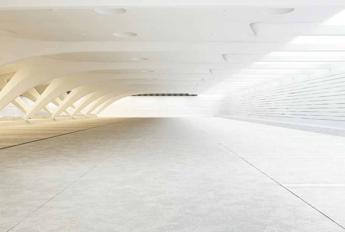 Modern architectural interior featuring white structural beams and smooth flooring, emphasizing spaciousness and minimalist design.